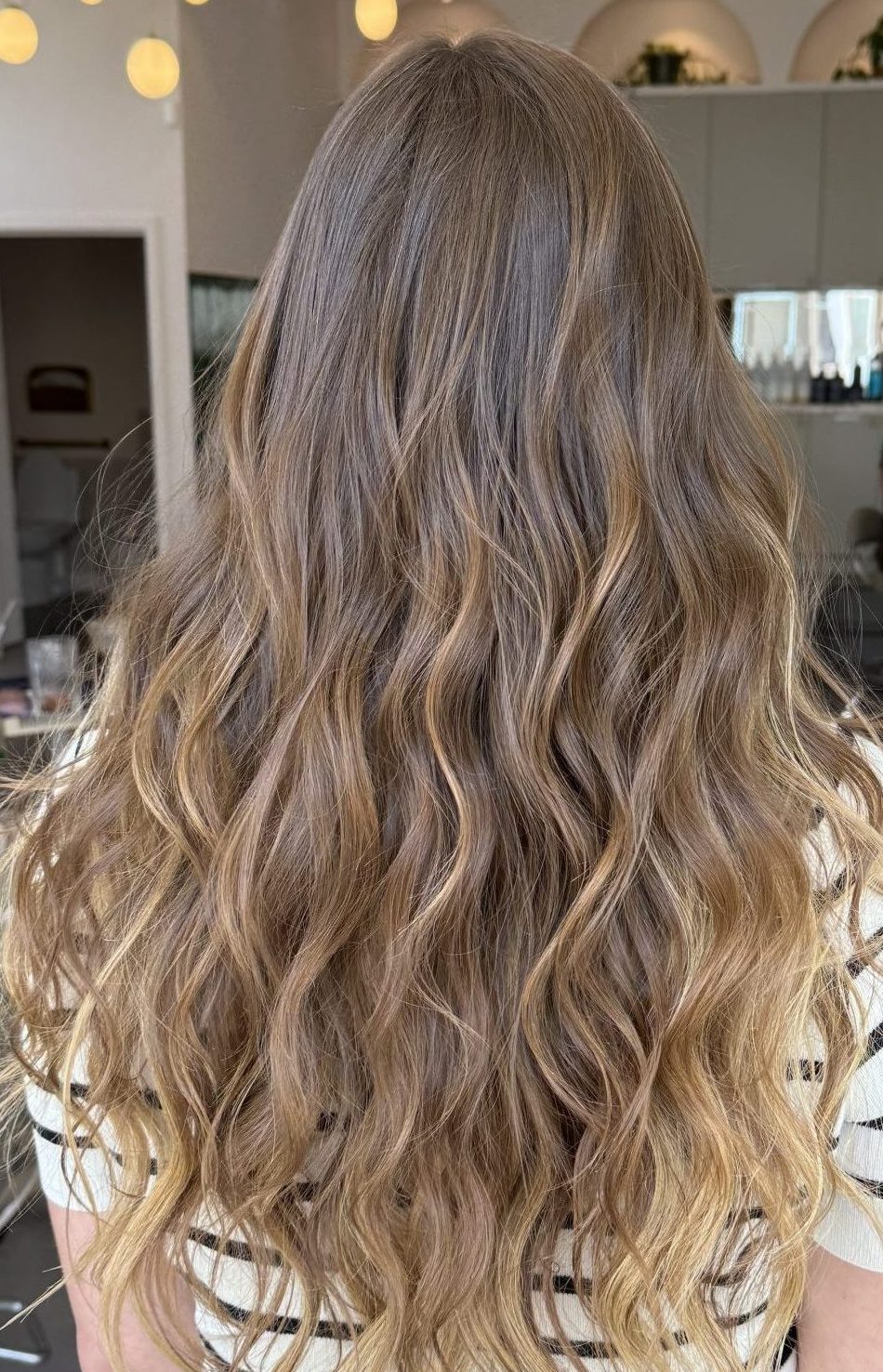 Long curled light brown hair with golden highlights